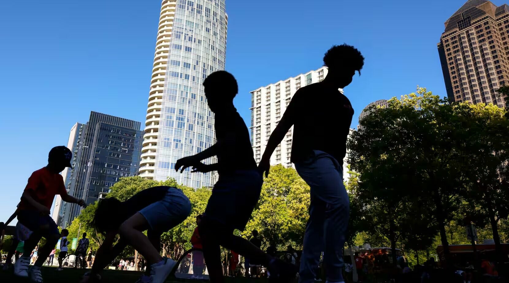 Kids play on the open lawn of Klyde Warren Park on Sunday, April 7, 2024 in Dallas. The answer to the 10 questions on the May 4 ballot is clear, writes Mayor Eric Johnson, Dallas needs this bond package to remain competitive at the regional, national and international levels.(Shafkat Anowar / Staff Photographer)